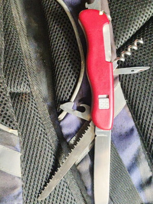 Victorinox Outrider multitool used with wood saw and large blade