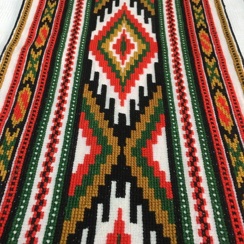 Set of handmade cross-stitch table runners with geometric patterns