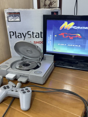 PlayStation 1 SCPH-5502 console with 2 controllers, memory card, cheat cartridge, and MRASER game