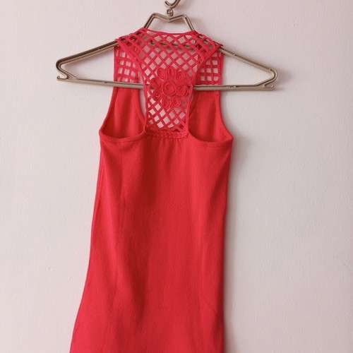 Red sleeveless blouse like new with white shorts and striped belt