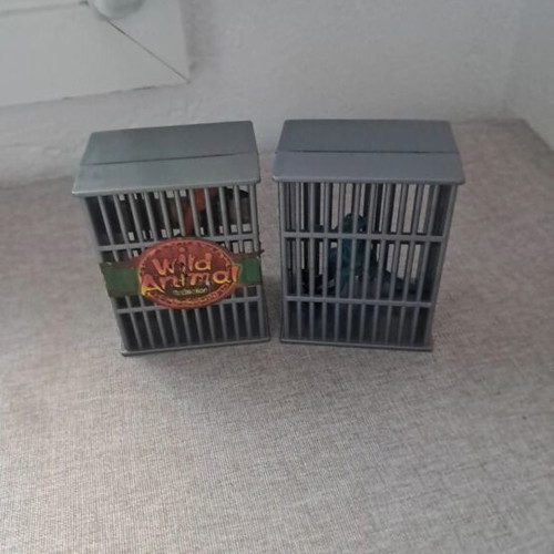 Dinosaur figures used, set in cages