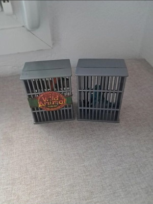 Dinosaur figures used, set in cages