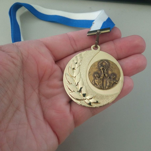 Gold victory medal new with blue and white ribbon