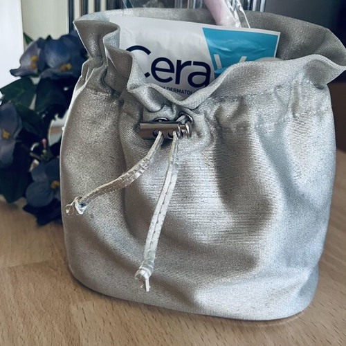 Beauty Bazaar Silver Pouch with Cosmetics Like New, 7 Pieces