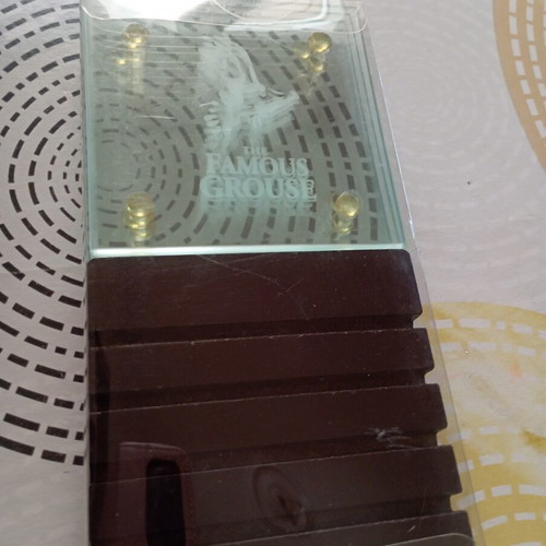 The Famous Grouse collectible glass coaster set with black ribbed base