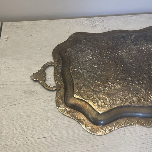 Vintage metal serving tray used with embossed floral and geometric carvings