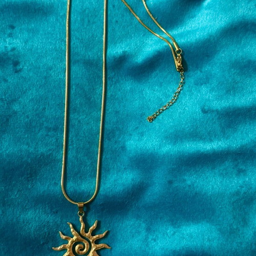 Gold necklace with sun pendant, new condition