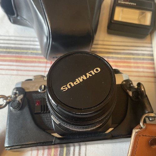 Olympus camera with tripod, flash and lens unused