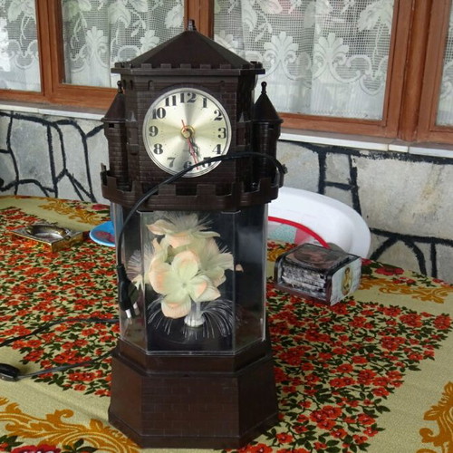 Table clock used collectible with lighting and rotating flower