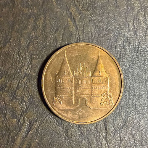 Collectible metal medal with embossed Holstentor design
