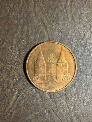 Collectible metal medal with embossed Holstentor design