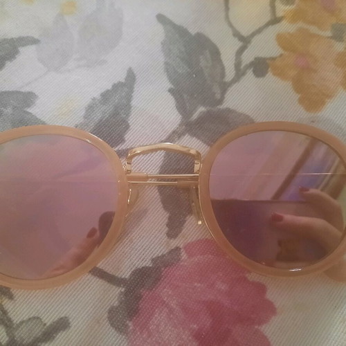 Sunglasses used with round pink lens and gold frame