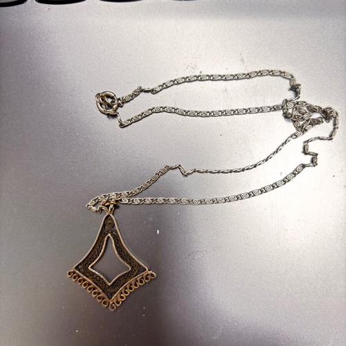 Silver vintage pendant with intricate chain