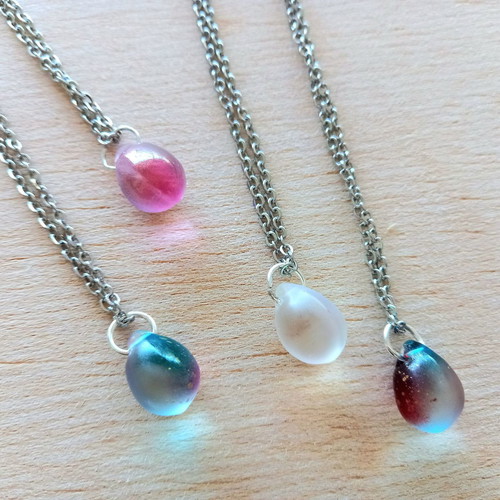 Handmade pendants from iridescent glass and steel