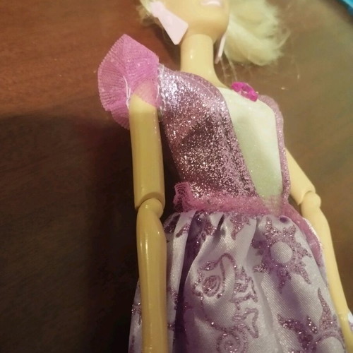 Doll with pink earrings and articulated joints used