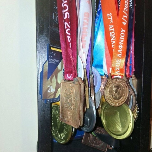 Handmade wooden medal display case with running race medal collection used