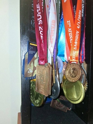 Handmade wooden medal display case with running race medal collection used