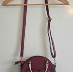 Round red shoulder bag