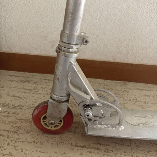 Silver metal scooter used, lightweight and foldable