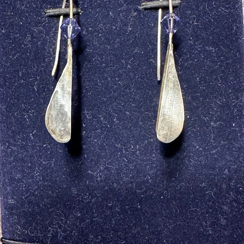 Silver earrings used with purple stones