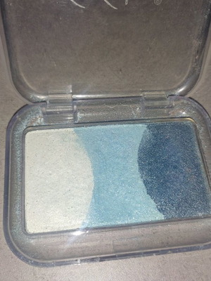 Triple eyeshadow palette used in iridescent blue shades
