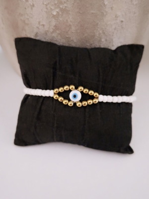 Handmade bracelet with white and gold beads, eye design, adjustable