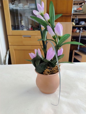 Terracotta pot decorated with artificial plants like new