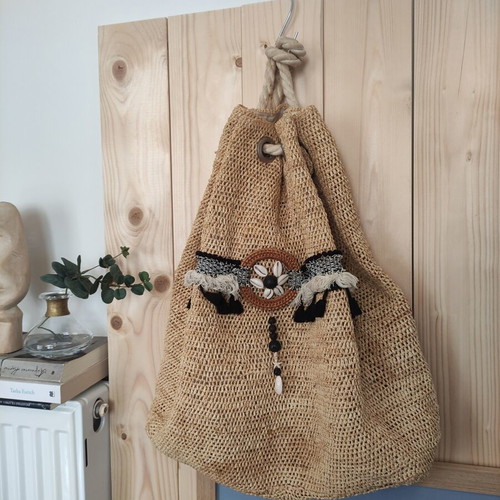 Boho straw backpack used with shells and rope straps, resort style
