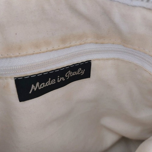 White bucket handbag used with decorative buttons