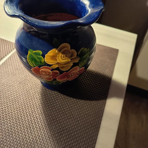 Handmade traditional clay vase with painted flowers