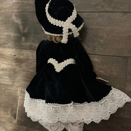 Porcelain doll with velvet dress and wooden chair like new