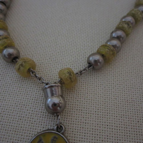 Vintage knotted AEK komboloi used with metal emblem