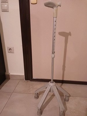 Walking cane with four-legged base used