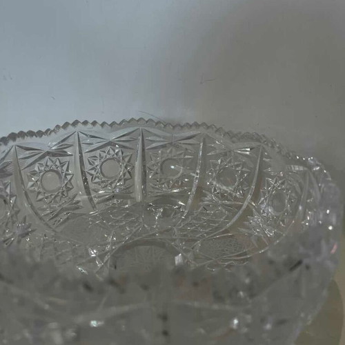Vintage crystal bowl with feet and embossed carved designs, used