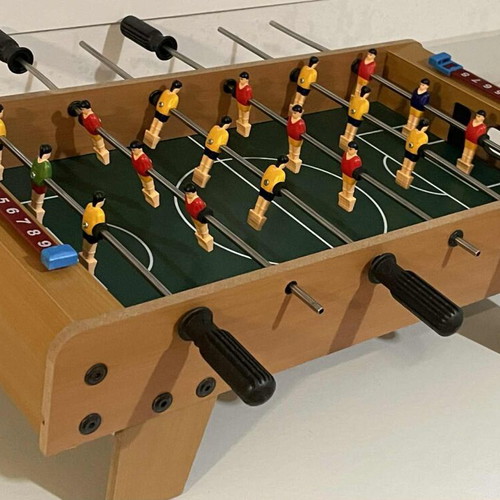 Children's foosball table used without balls and missing one handle