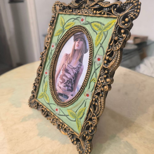 Vintage photo frame with oval opening and embossed design like new