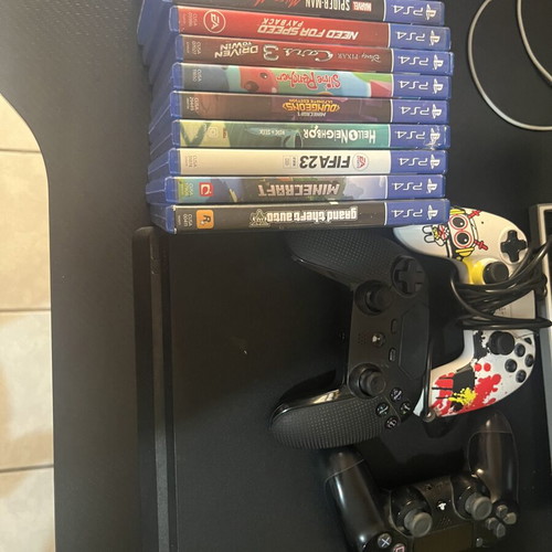 Sony PlayStation 4 Slim console used with 3 controllers and cables