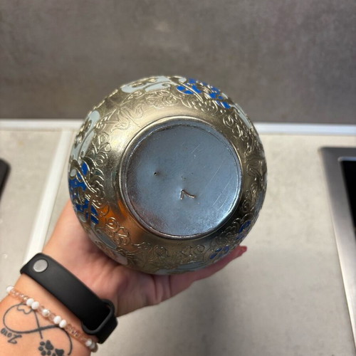 Vintage metal vase used with embossed designs and blue details