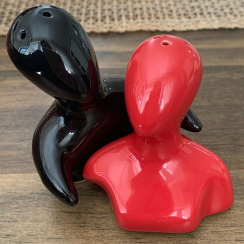 Salt and pepper shakers hugging pair like new