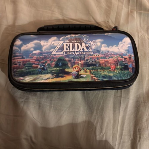 Nintendo Switch console with carrying case and Pokemon Sword game