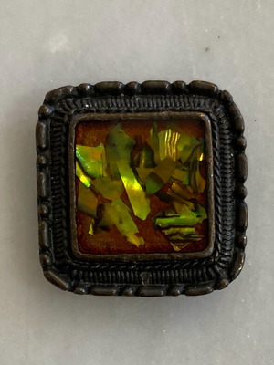 Vintage button in antiqued metal with embossed design and polychrome resin like new