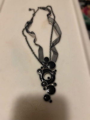 Necklace with black ribbon and metal chain, large pendant with black and gray circles