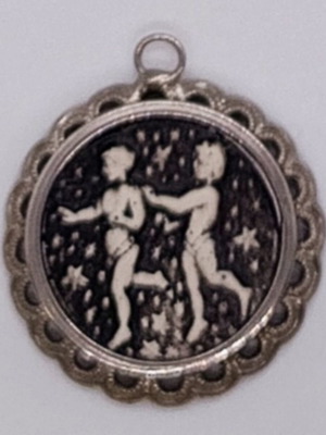 Embossed Gemini pendant like new, silver