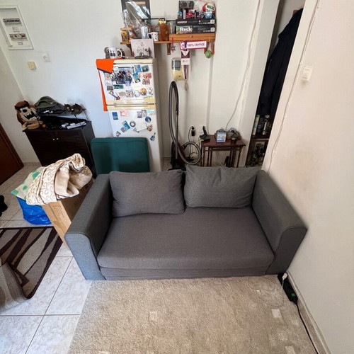Two-seater grey sofa bed