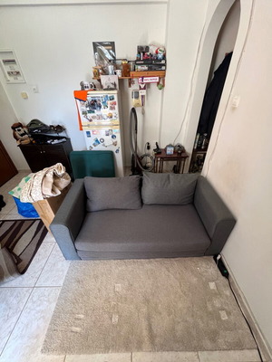Two-seater grey sofa bed