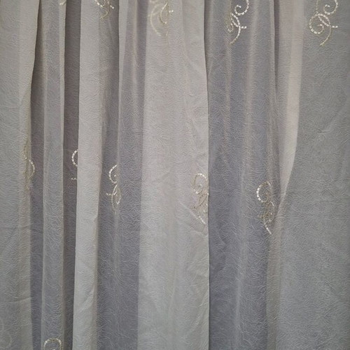 Set of two ready-sewn curtains in sugar color with embroidered designs
