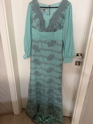Long turquoise dress with lace embroidery and satin details