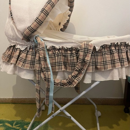 Wicker bassinet like new with base, wheels and cushion