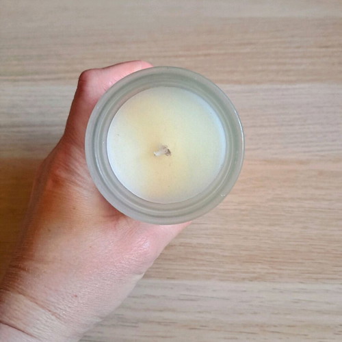 White candle in container new