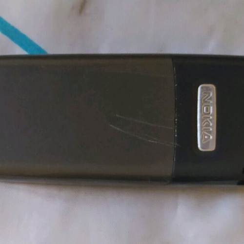 Old mobile phone used, functional, almost unused, gray with game